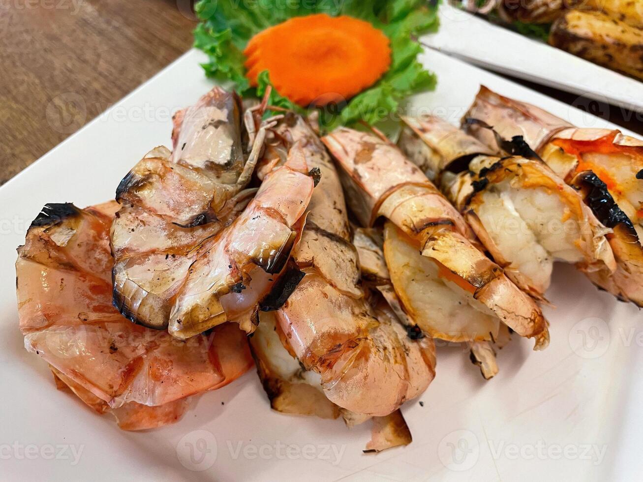Grilled tiger prawns served on a plate photo
