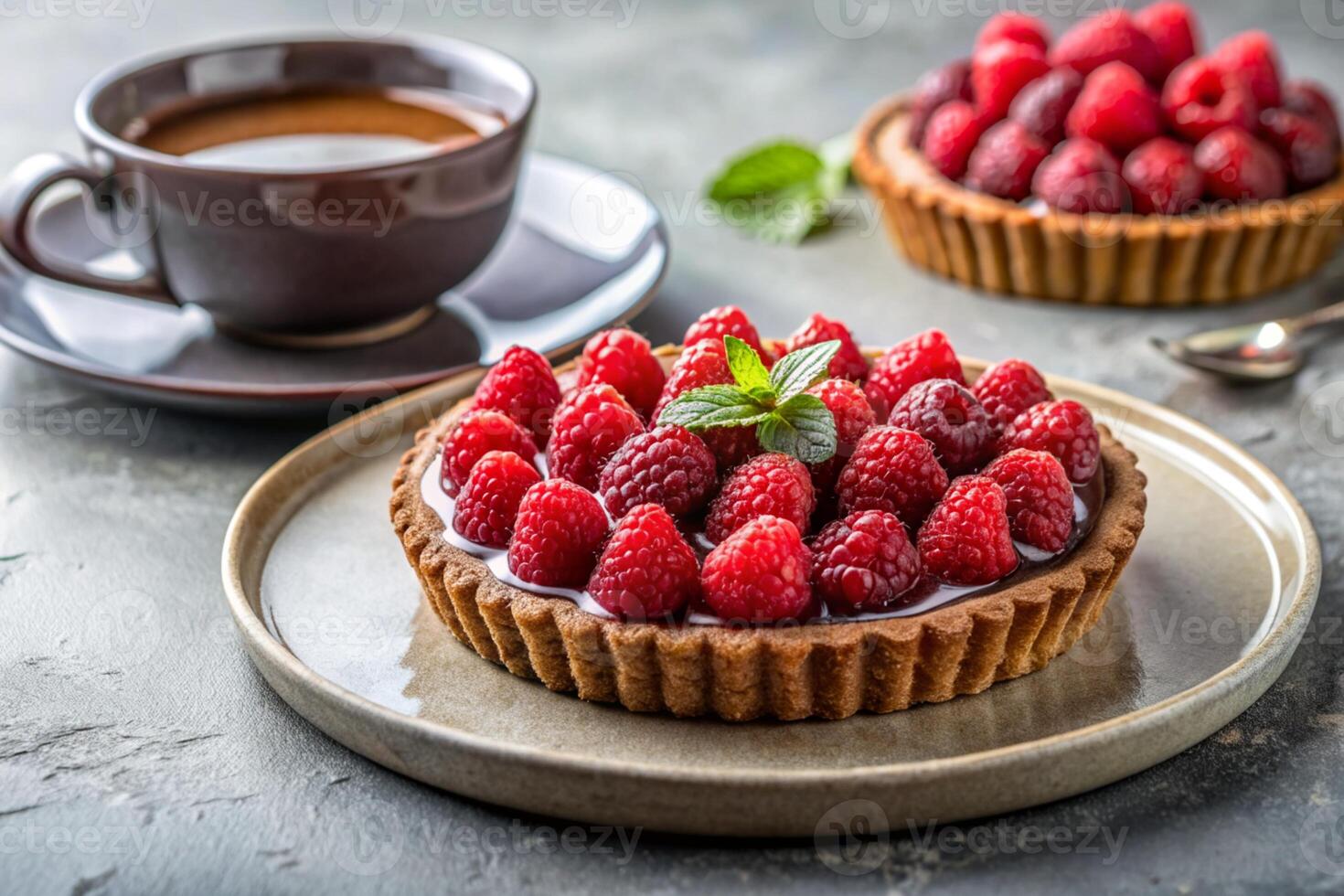Chocolate Raspberry piece of Tart on a grey plate and coffee cup photo
