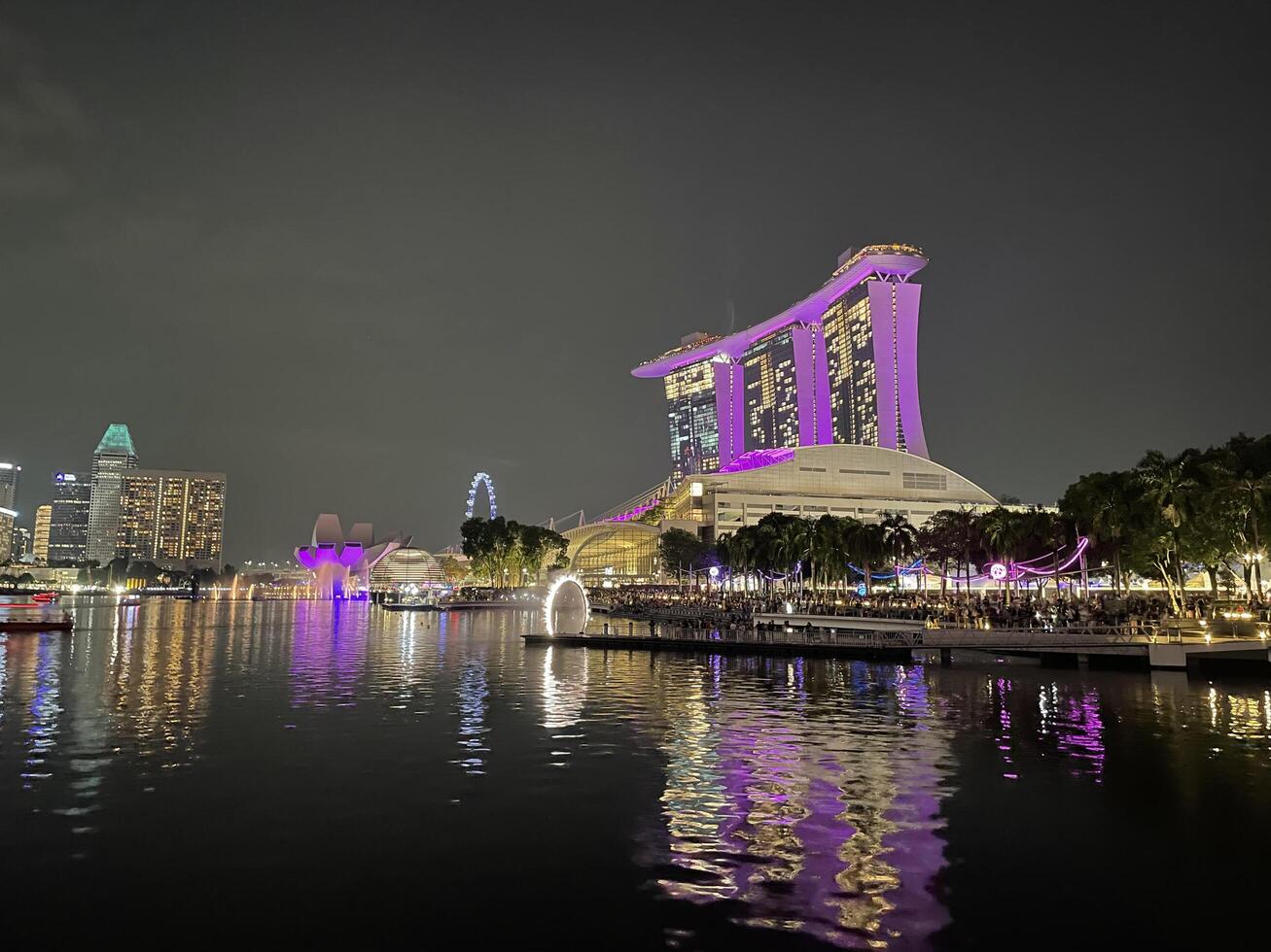Singapore June 9 2024 The Helix bridge, Marina Bay Sands and Art Science museum with downtown in background during sunset. Marina Bay is famous touristic attraction. photo