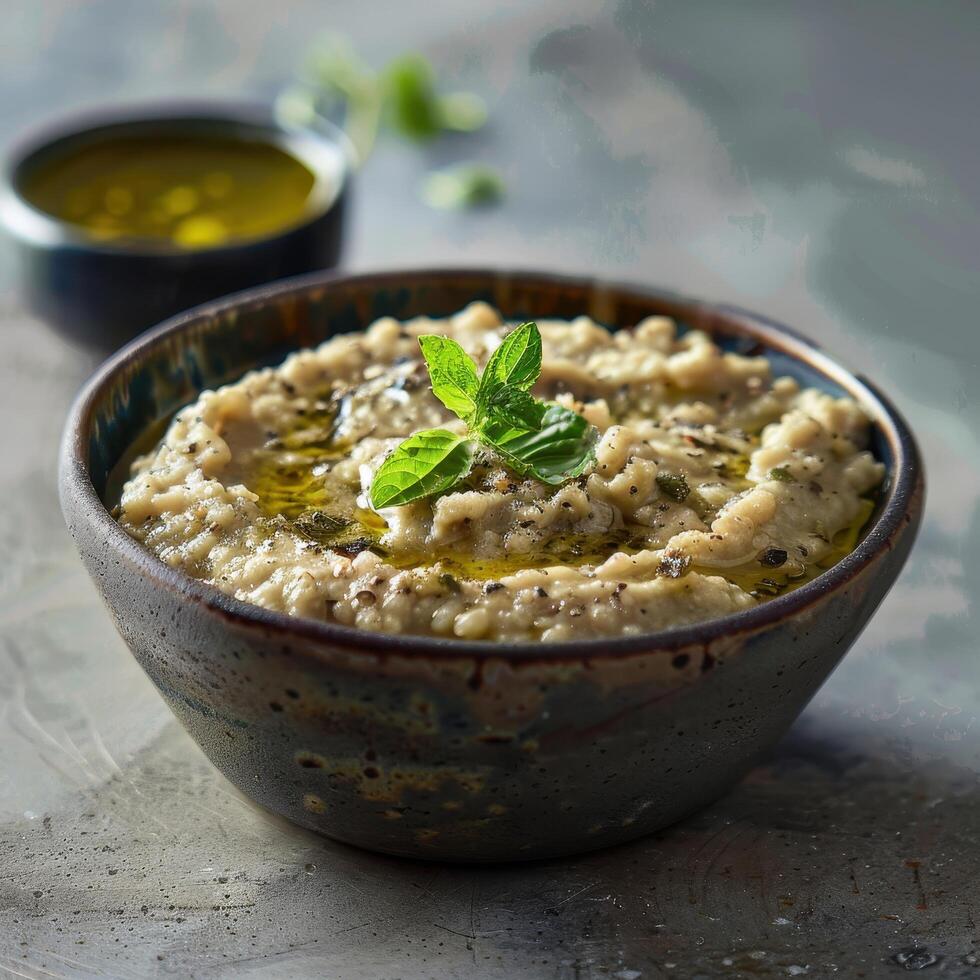 Creamy, Delicious Baba Ganoush with herbs, olives and olive oil. Traditional Middle Eastern eggplant dip with garnishes. photo