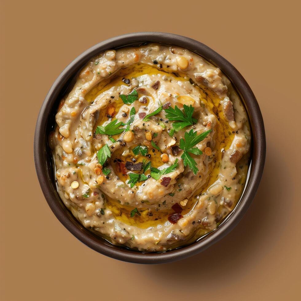 Delicious creamy eggplant baba ghanoush dip with olive oil, parsley, and spices. Traditional Middle Eastern cuisine. Top view. photo