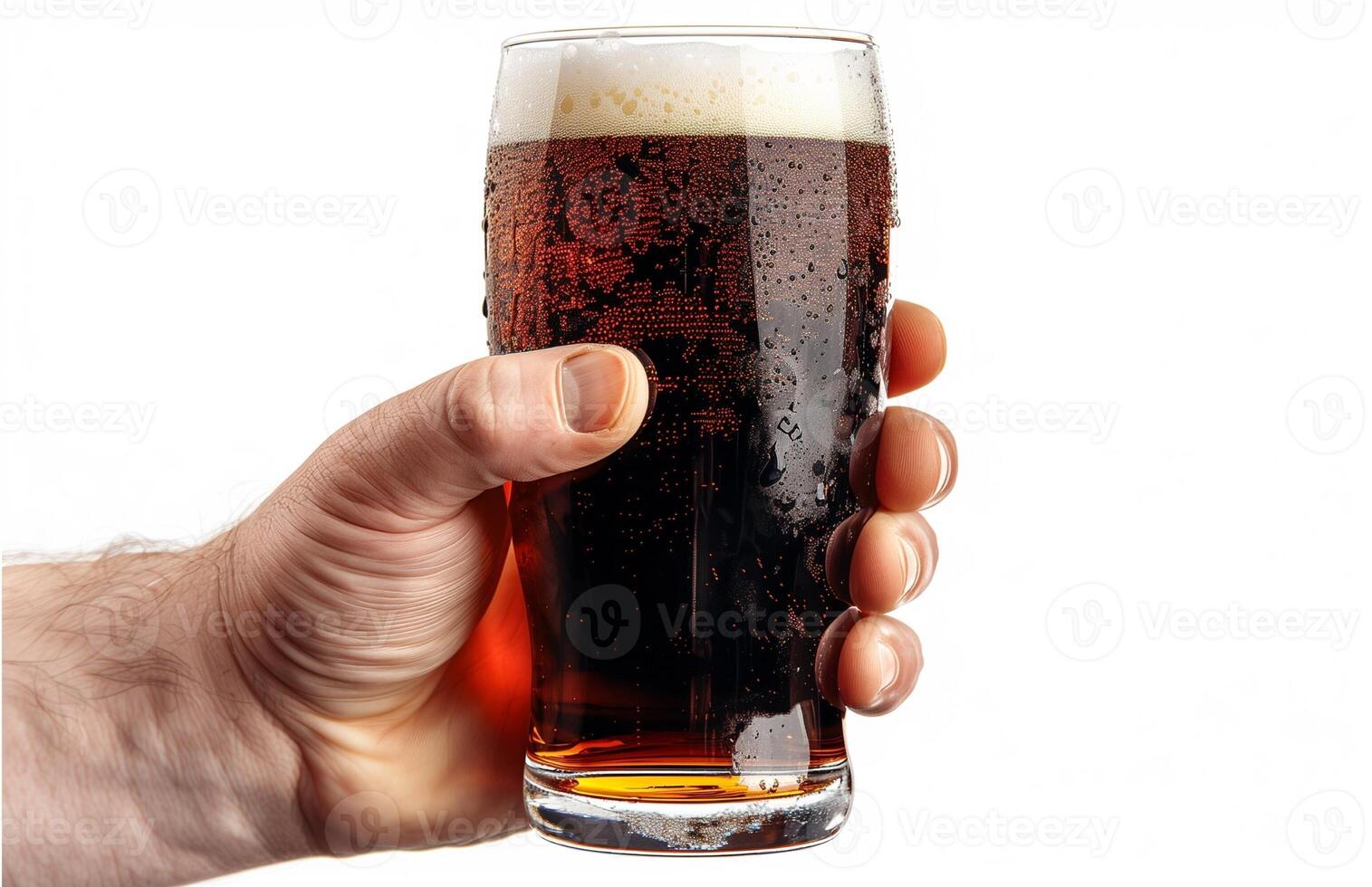Close up of a man's hand holding a glass with dark beer isolated on a white background photo