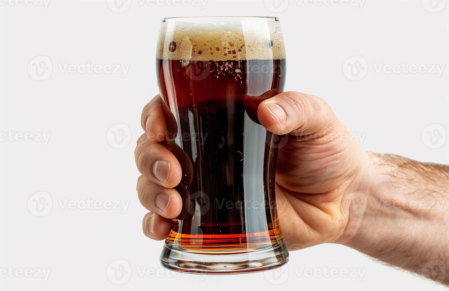 Close up of a man's hand holding a glass with dark beer isolated on a white background photo