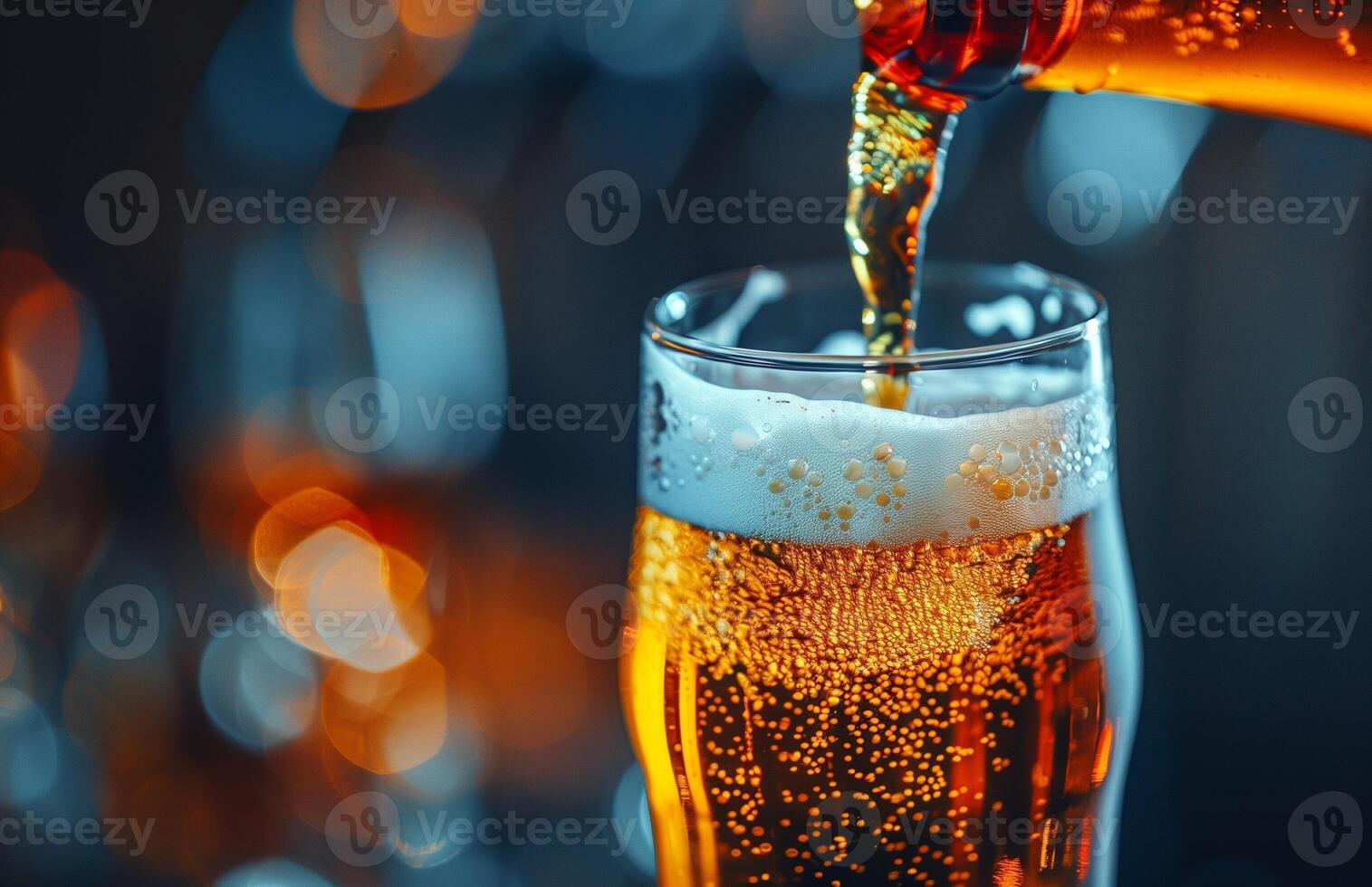 Pouring a glass of golden beer, creating a frothy head, ready to be enjoyed photo