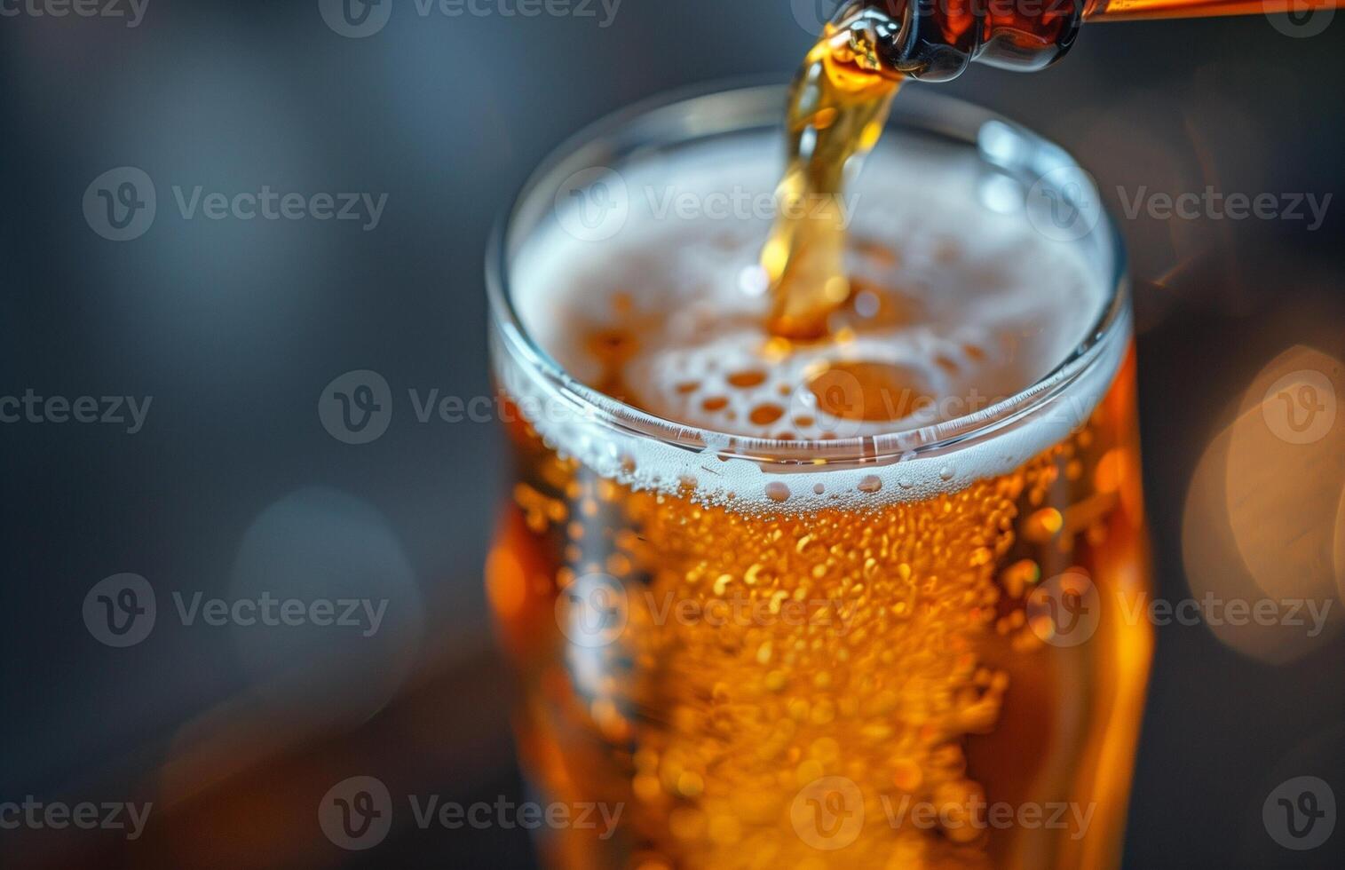 Pouring a glass of golden beer, creating a frothy head, ready to be enjoyed photo
