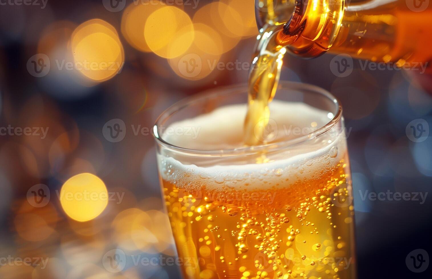 Pouring a glass of golden beer, creating a frothy head, ready to be enjoyed photo