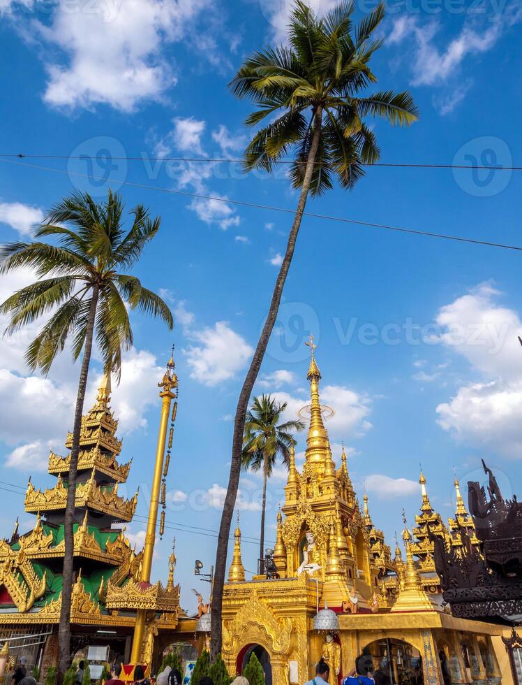 Group of golden pagoda and square hall mondop and golden tiered umbrella under the blue sky photo