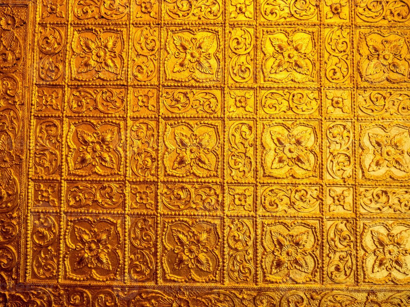 Burmese art pattern motifs decorative design on the golden walls of the rooms in the temple photo