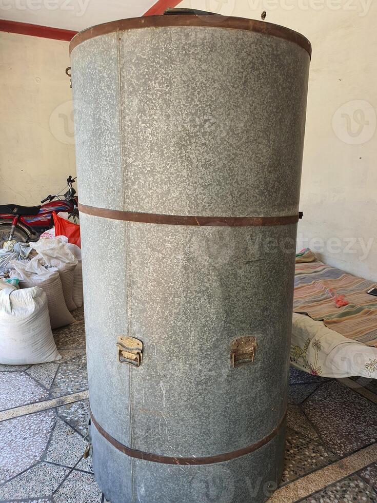 a wheat storage drum in background bags of wheat photo