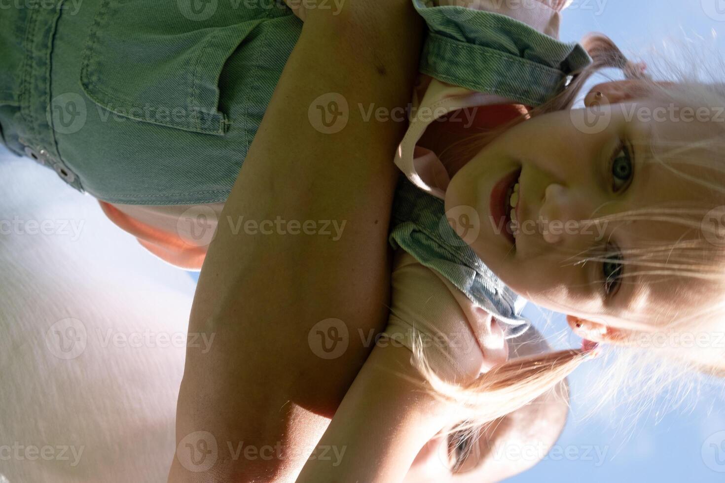 Captured from below, child held high suggests a world of possibilities, security that healthy living and comprehensive health insurance provide, and active lifestyle in nature. photo