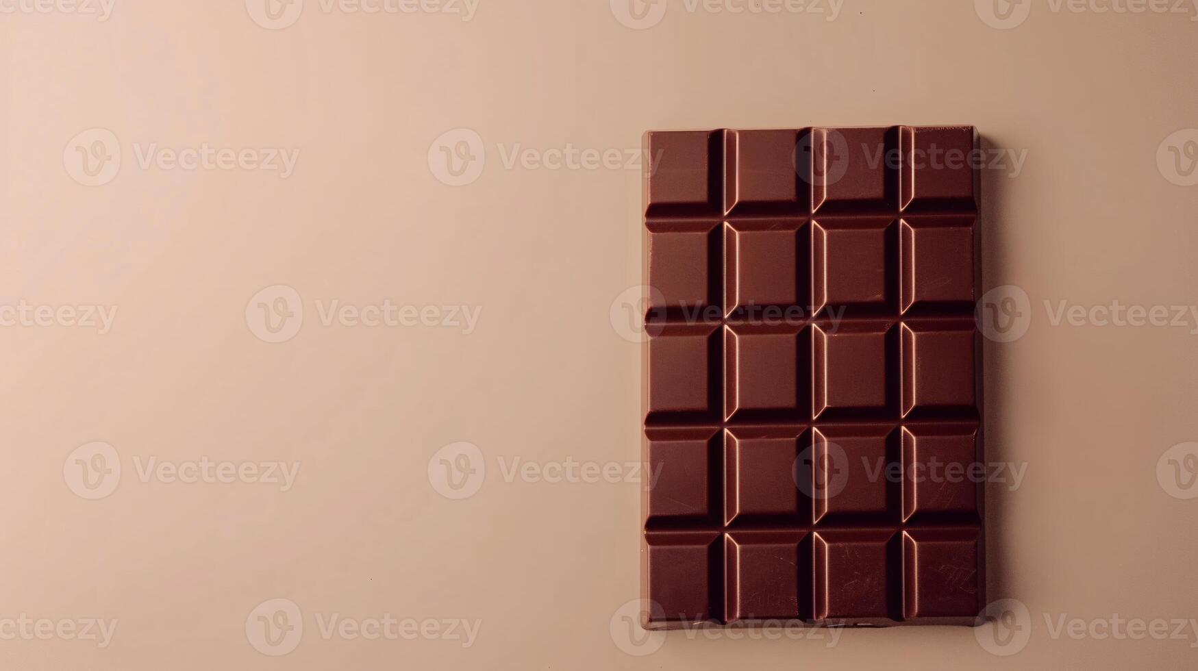 Dark chocolate bar on brown background. A simple yet elegant image of a dark chocolate bar against a brown backdrop, perfect for food blogs and websites. photo