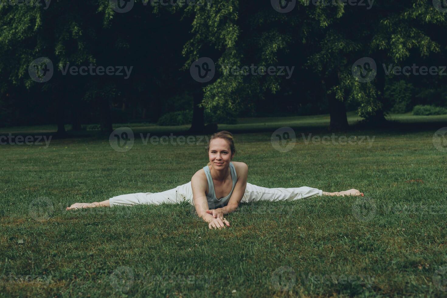 young woman athlete in sportswear practices yoga, enjoys training photo