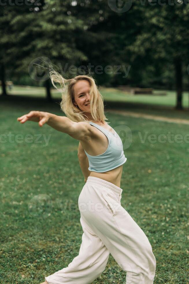 young woman athlete in sportswear practices yoga, enjoys training photo