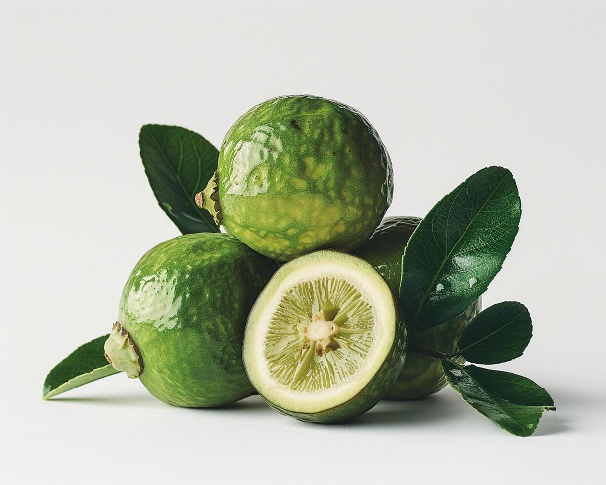 a green lime with leaves and a slice photo