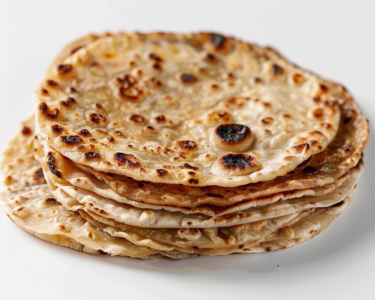 a stack of flatbreads on a white surface photo
