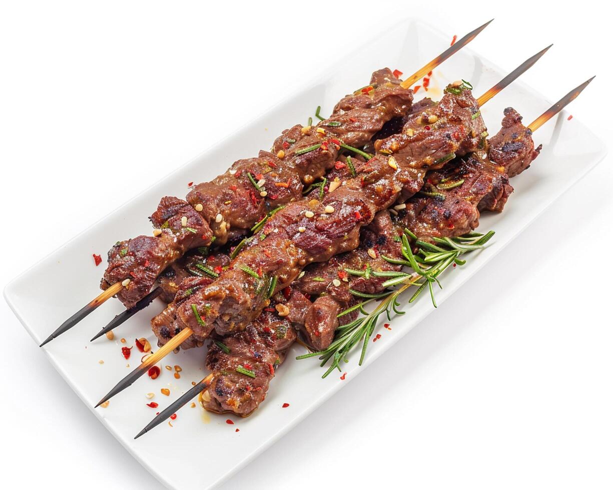 a plate of meat skewers with rosemary and spices photo