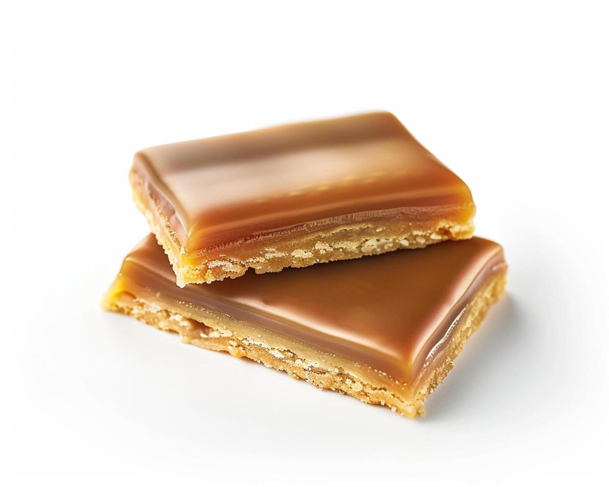 two pieces of caramel bars on a white background photo