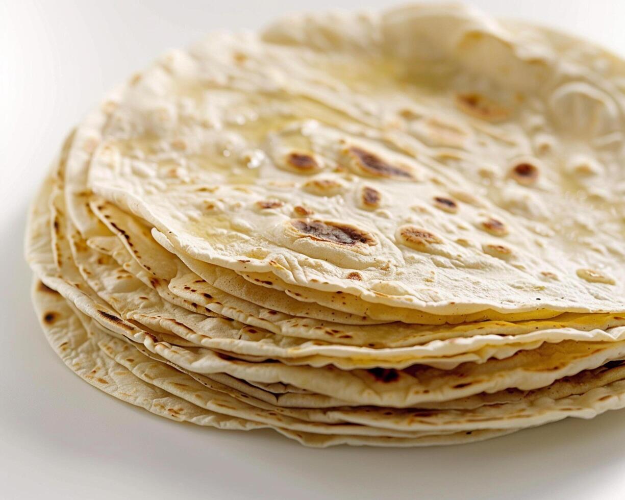 a stack of tortillas on a white surface photo