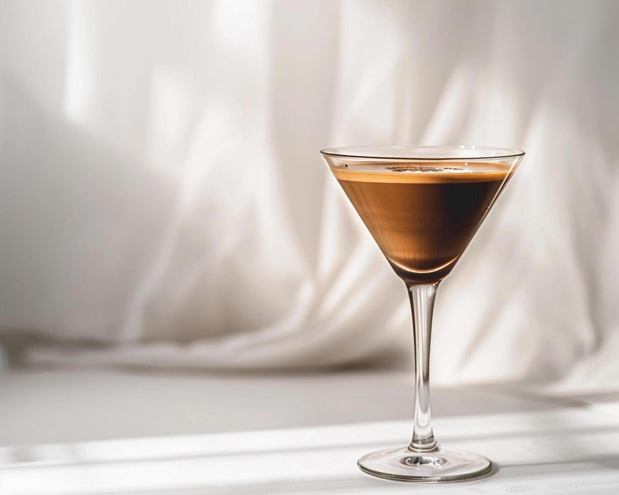 a glass of coffee sitting on a table photo