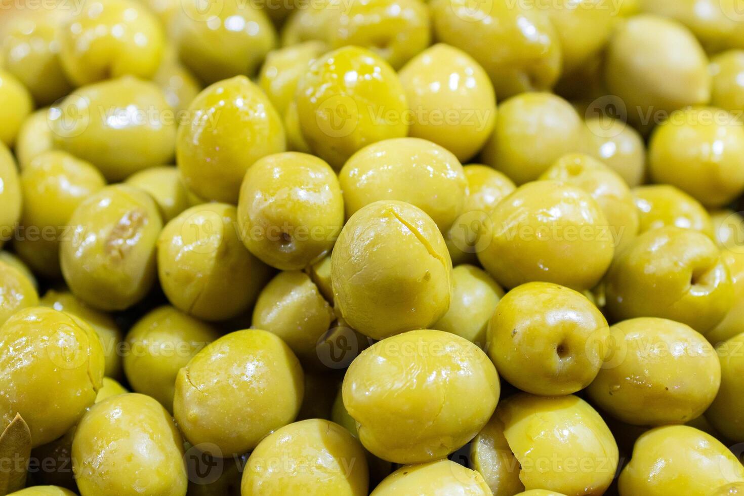Split green olives background. Spanish appetizer photo