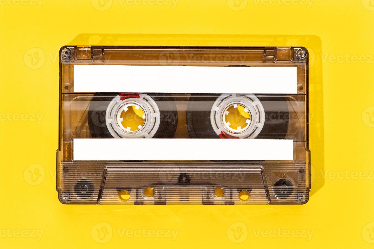 Old tape cassette with blank labels isolated on yellow background, Template mock up photo
