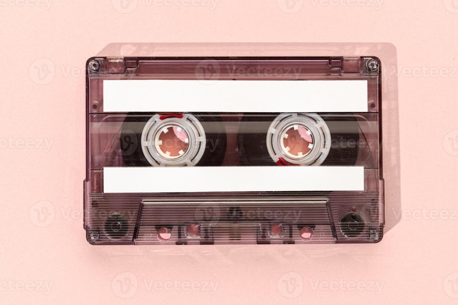 Old tape cassette with blank labels isolated on pink background, Template mock up photo
