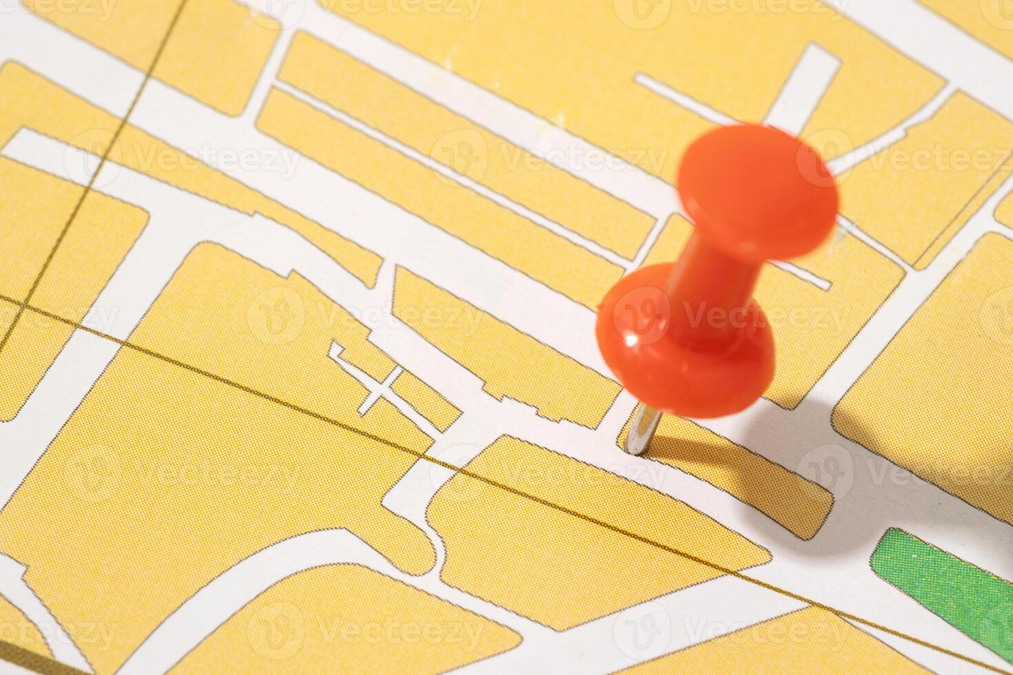 Thumbtack on a paper city map. Map location concept photo