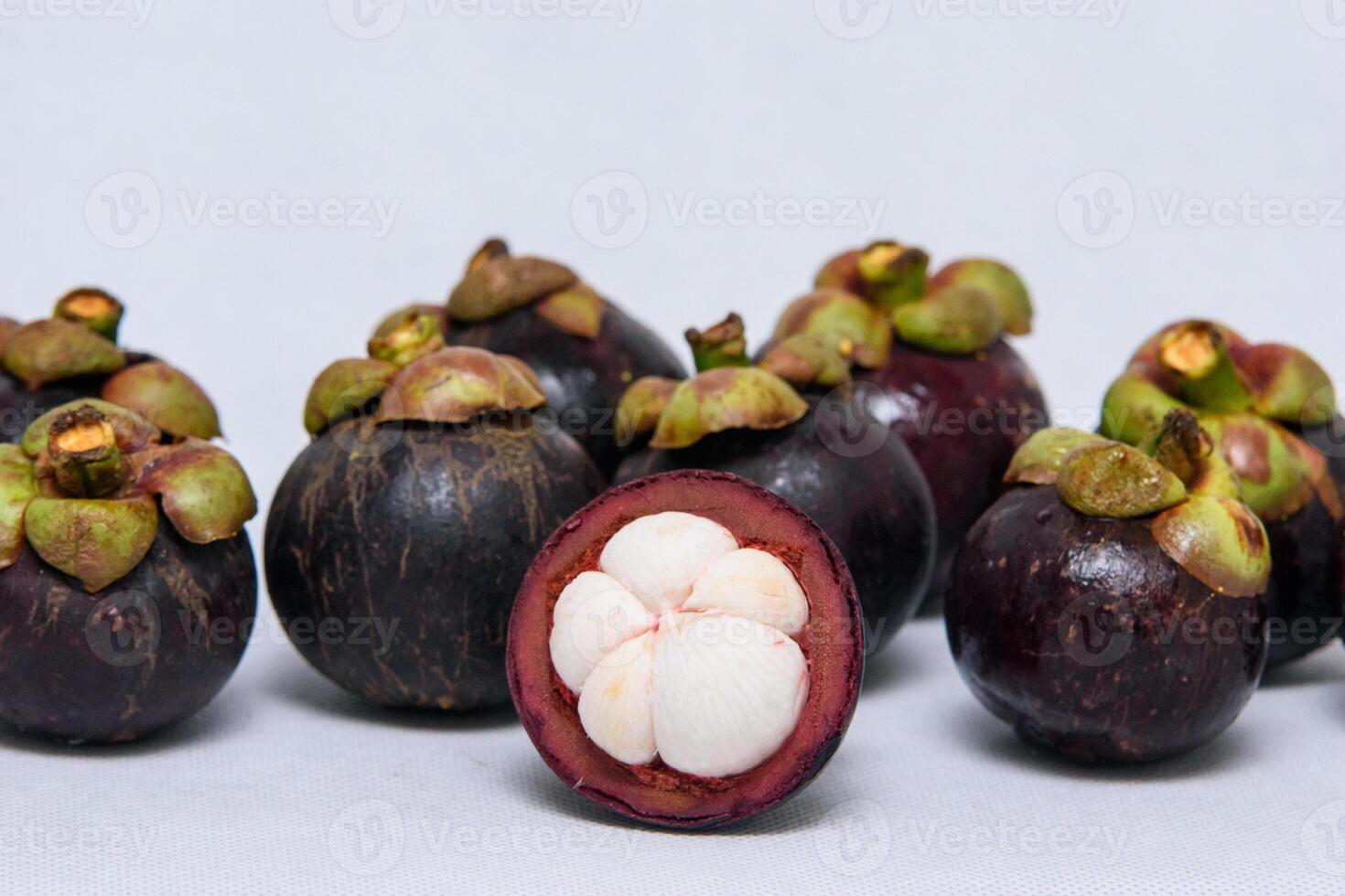 Queen of fruit. Mangosteens on the white background. photo