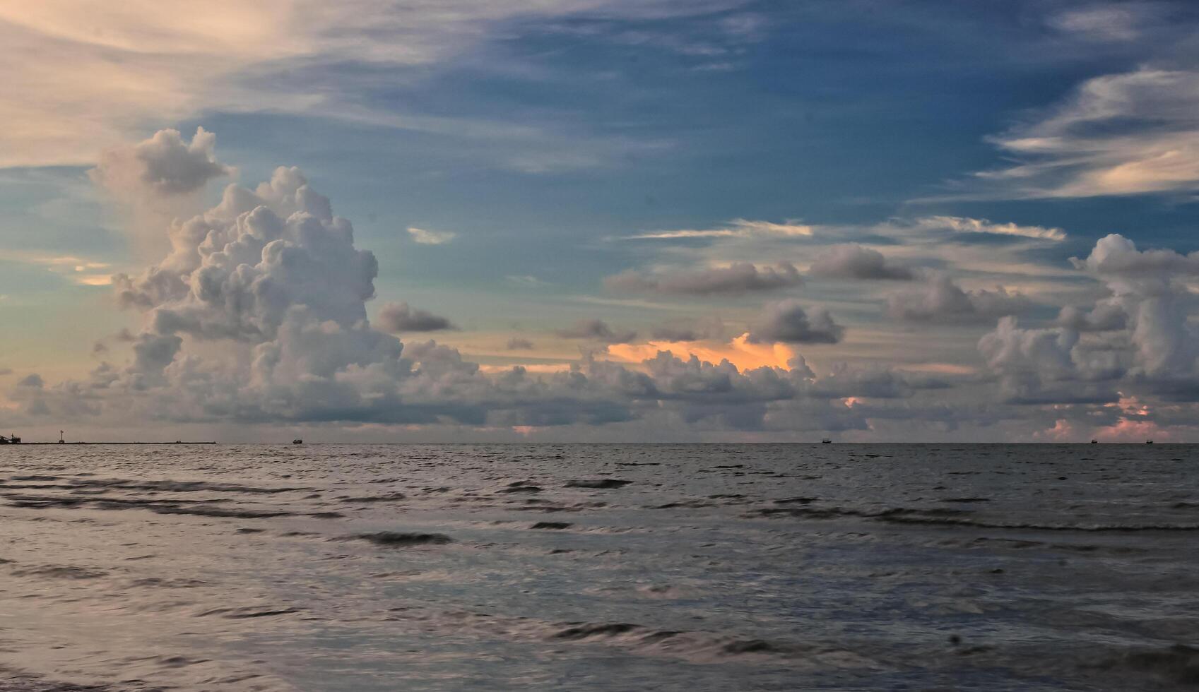 view of the sea in the afternoon with a cloudy sky photo