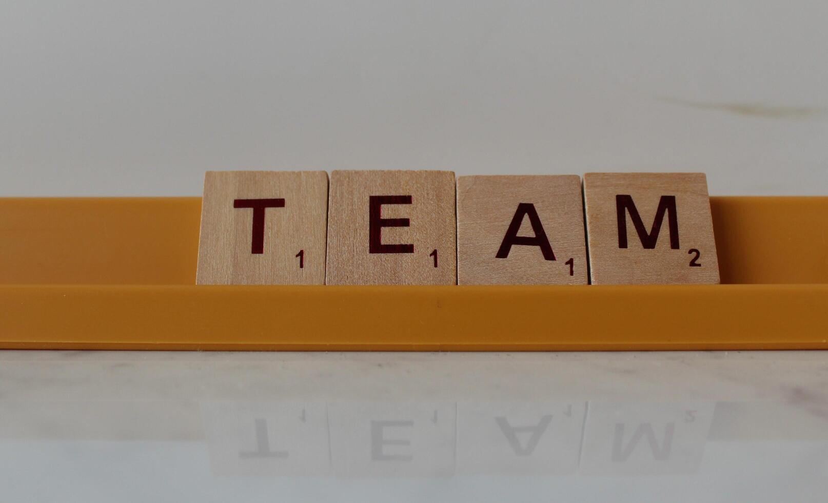 Kohtla Jarve Estonia - 05 05 2024 The word TEAM, spelt with wooden letter tiles over a plain photo