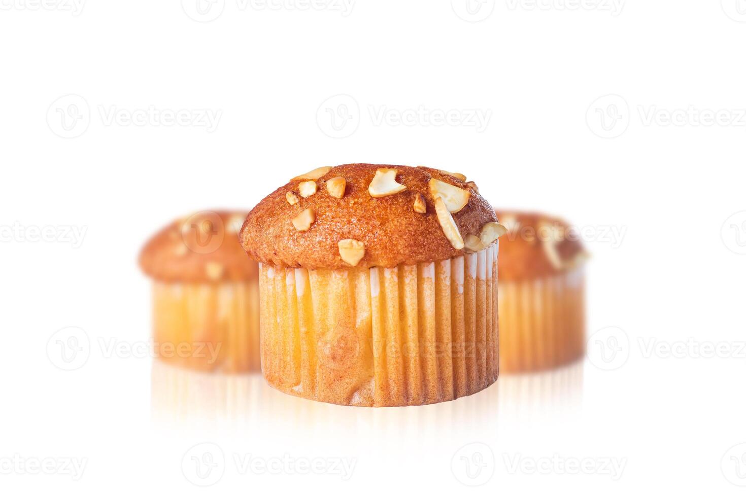 Close-up of delicious almond topped muffin with reflection on white background photo