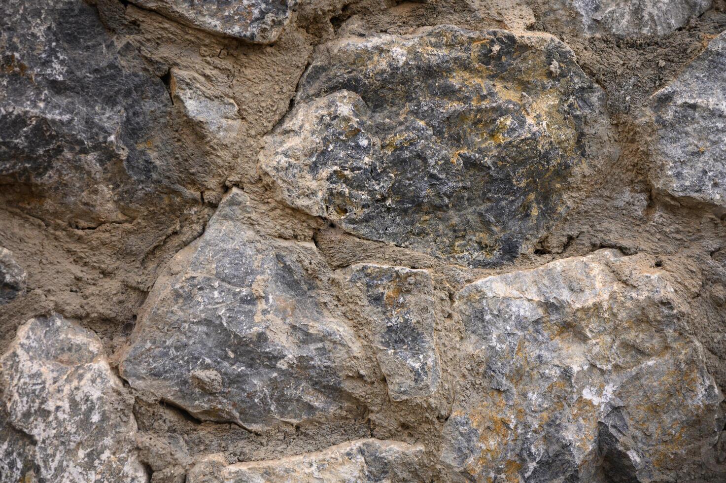 Texture of a stone wall. Old castle stone wall texture background. photo