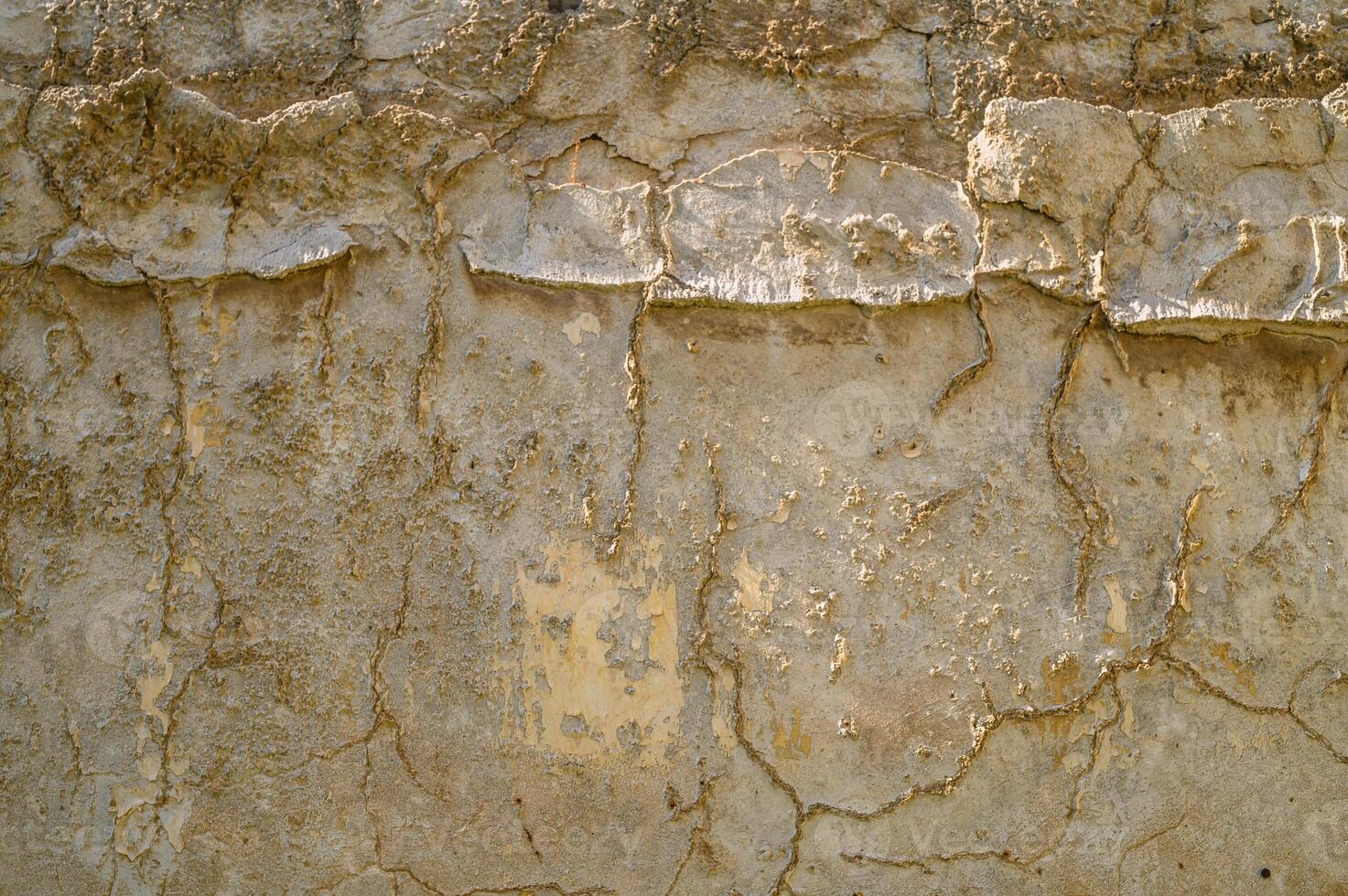 yellow texture of cracked concrete wall. Abstract background of a crack in a concrete wall. photo