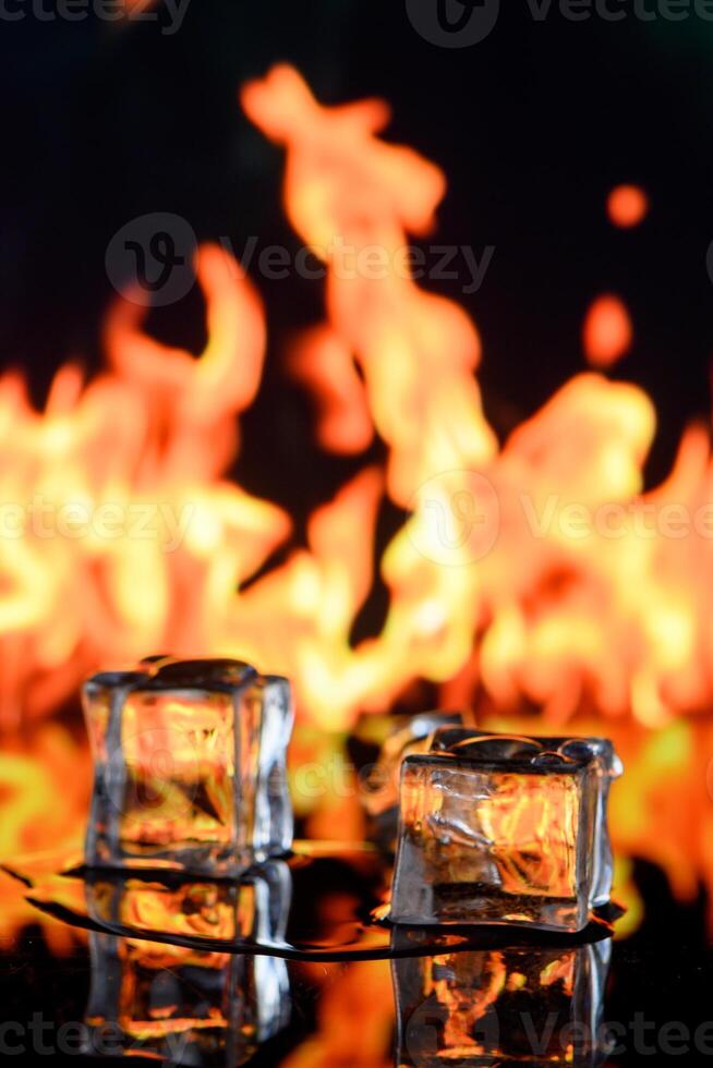 cubes of ice and fire on a water surface on an abstract background photo