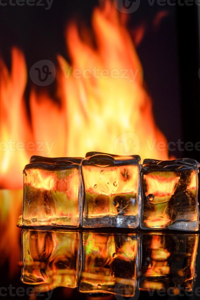 cubes of ice and fire on a water surface on an abstract background 3 photo