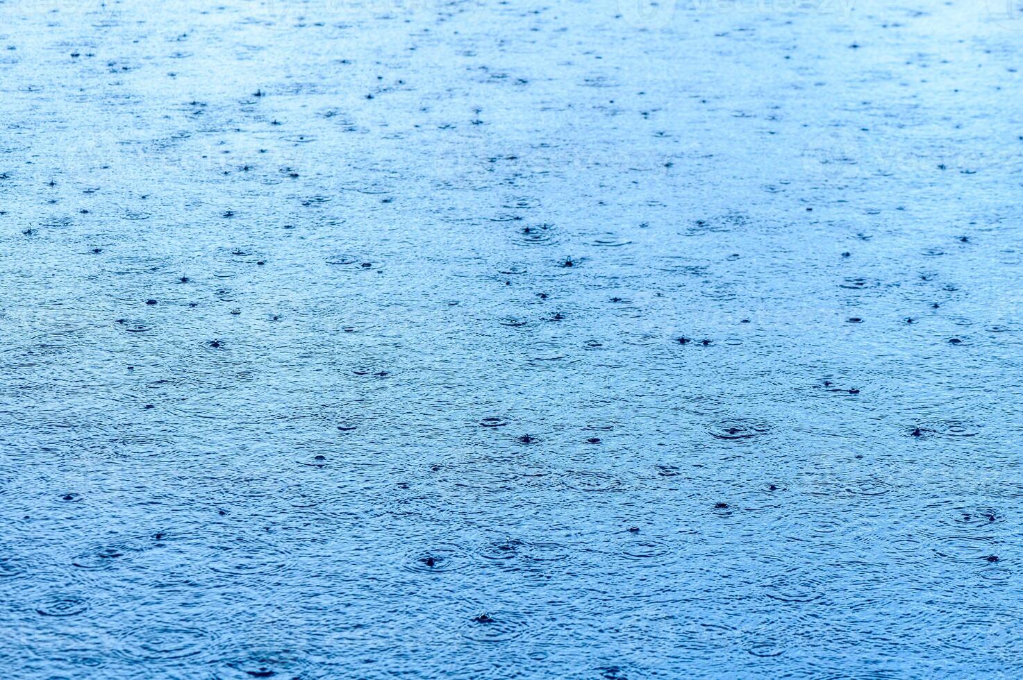 Defocus blurred transparent blue colored clear calm water surface texture with splashes and bubbles.2 photo
