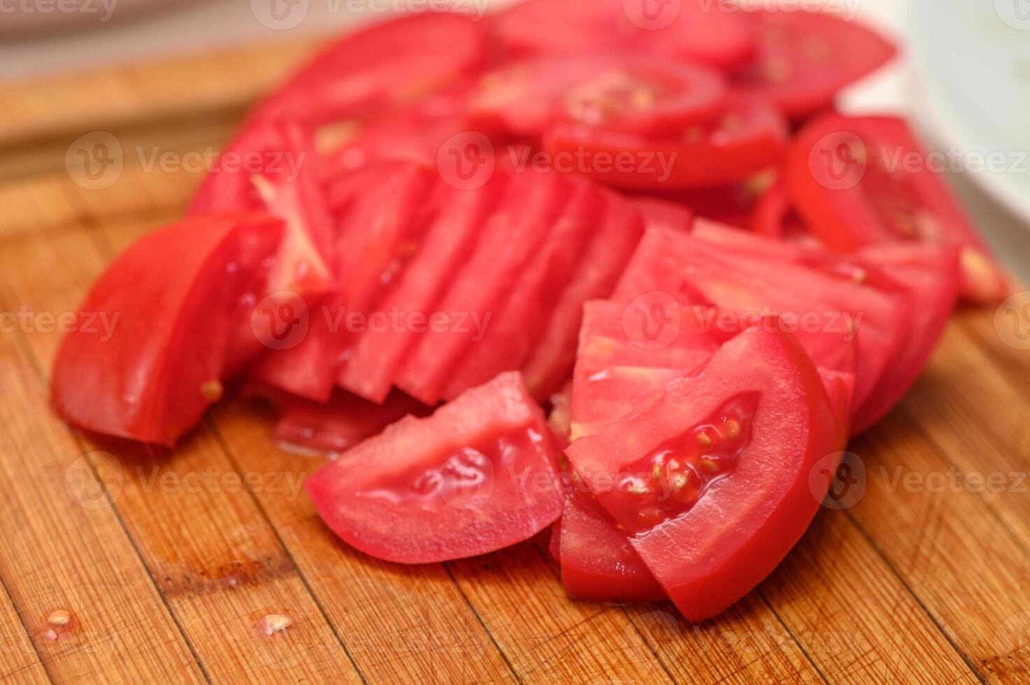 woman cutting tomato on kitchen board 9 photo