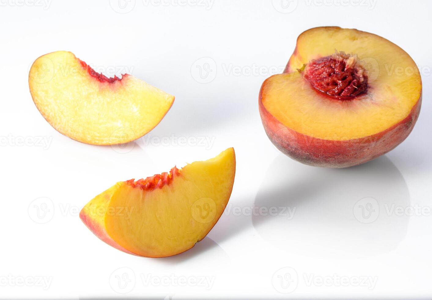 Peach isolated. Whole peach with a slice on white background. Peach fruit with leaf and cut pieces. Full depth of field. photo