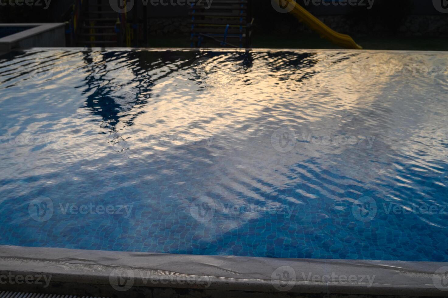 reflection of the sunset sky in the swimming pool photo