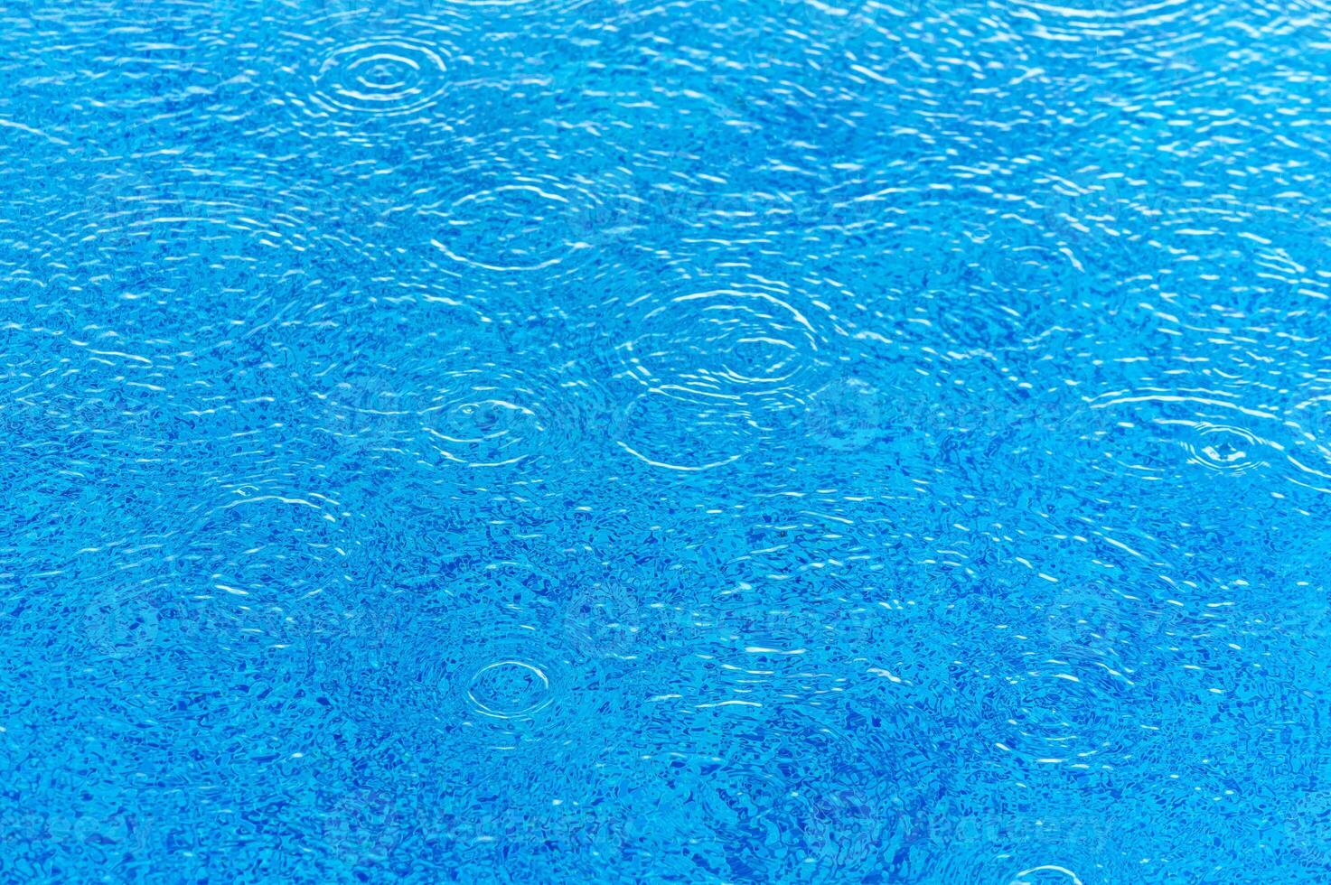 A transparent water with waves and light reflections on bottom. Top view photo