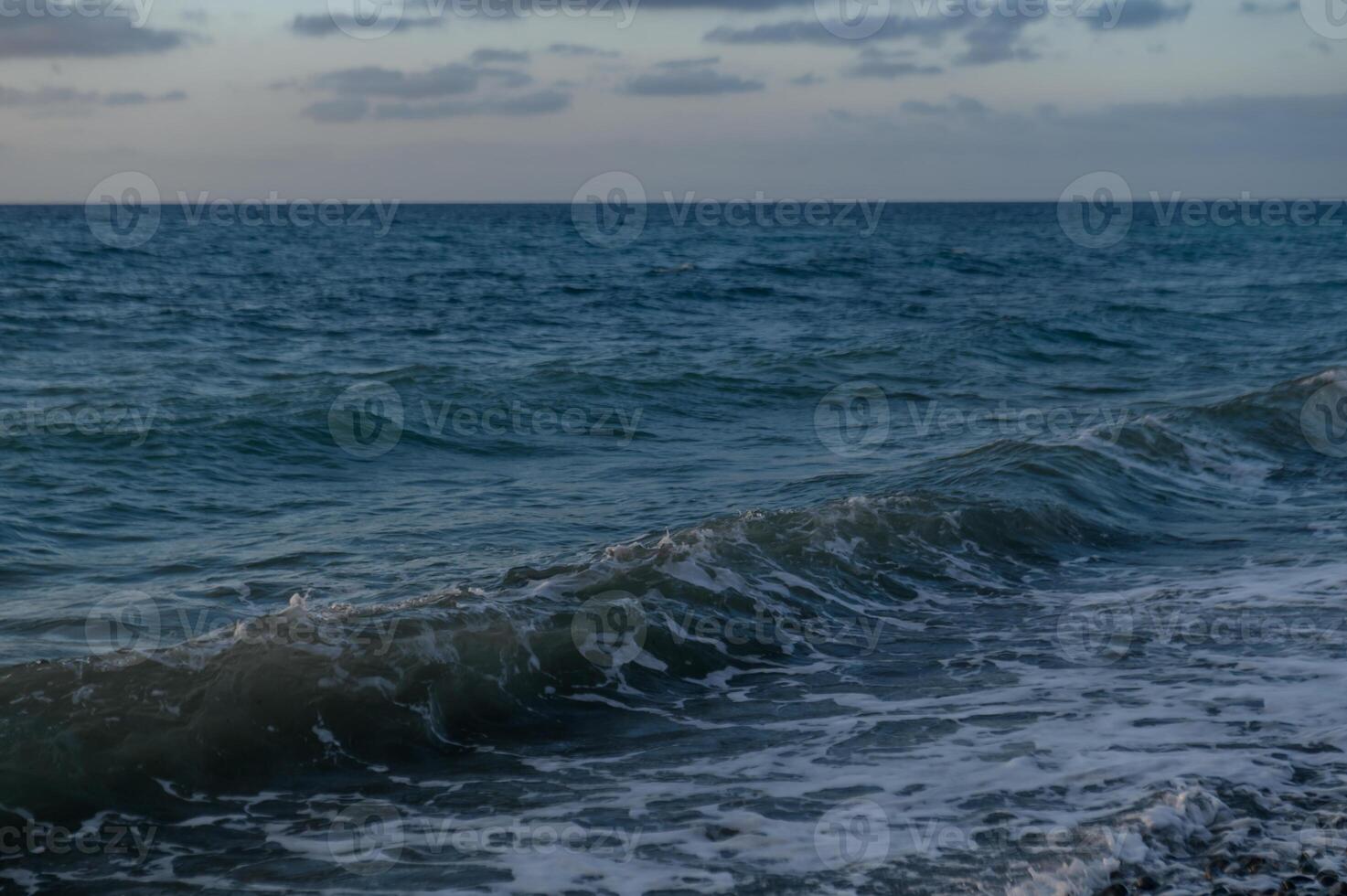 waves of the Mediterranean sea at sunset photo