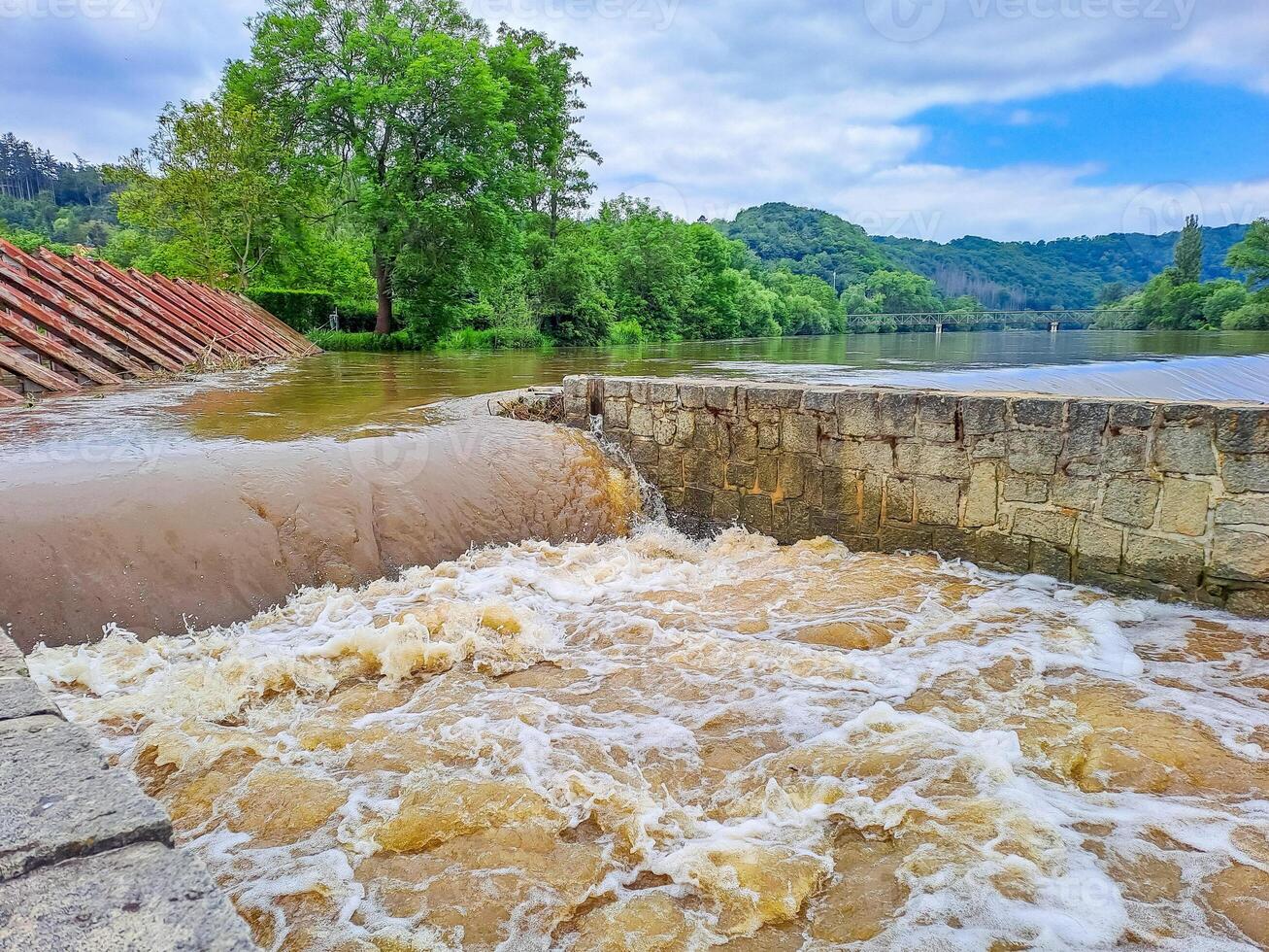 The river Berunka swollen after heavy rainfall and flood water crashing valley photo