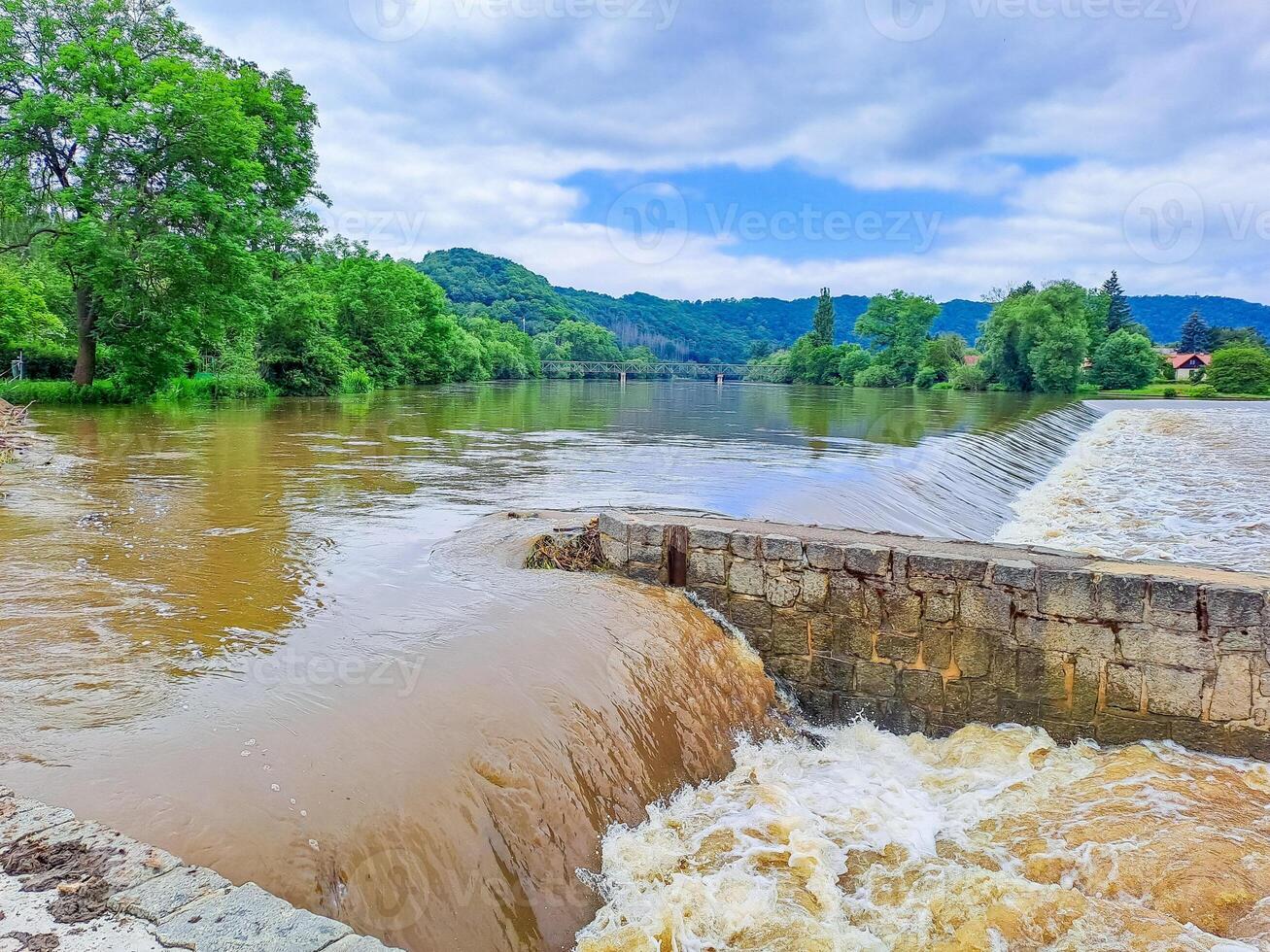 The river Berunka swollen after heavy rainfall and flood water crashing valley photo
