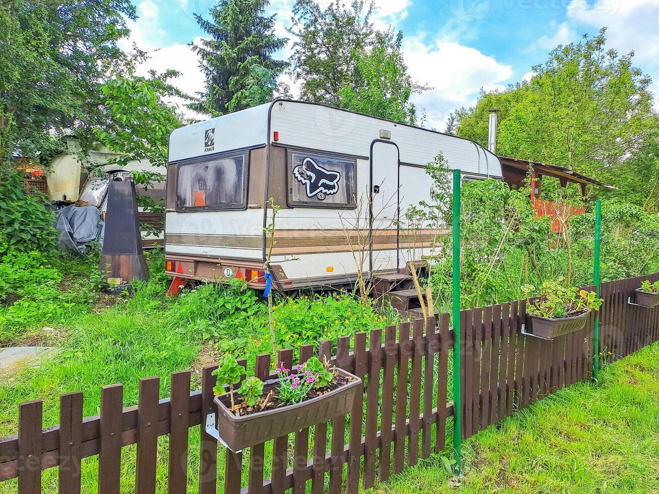 Camping house, row of small wooden huts or houses on green valley. Zadni Treban photo