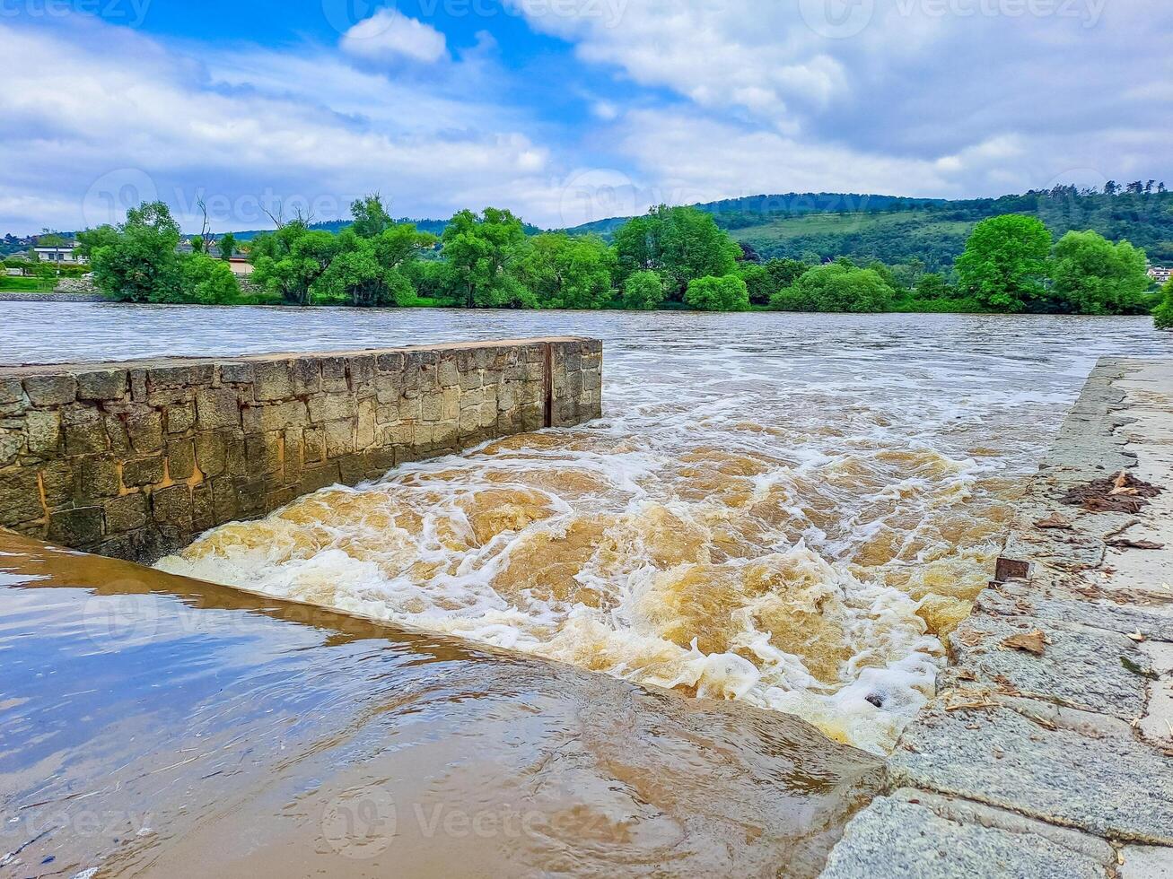 The river Berunka swollen after heavy rainfall and flood water crashing valley photo