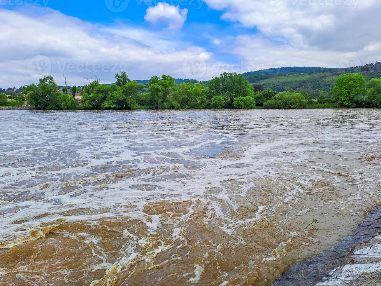 The river Berunka swollen after heavy rainfall and flood water crashing valley photo