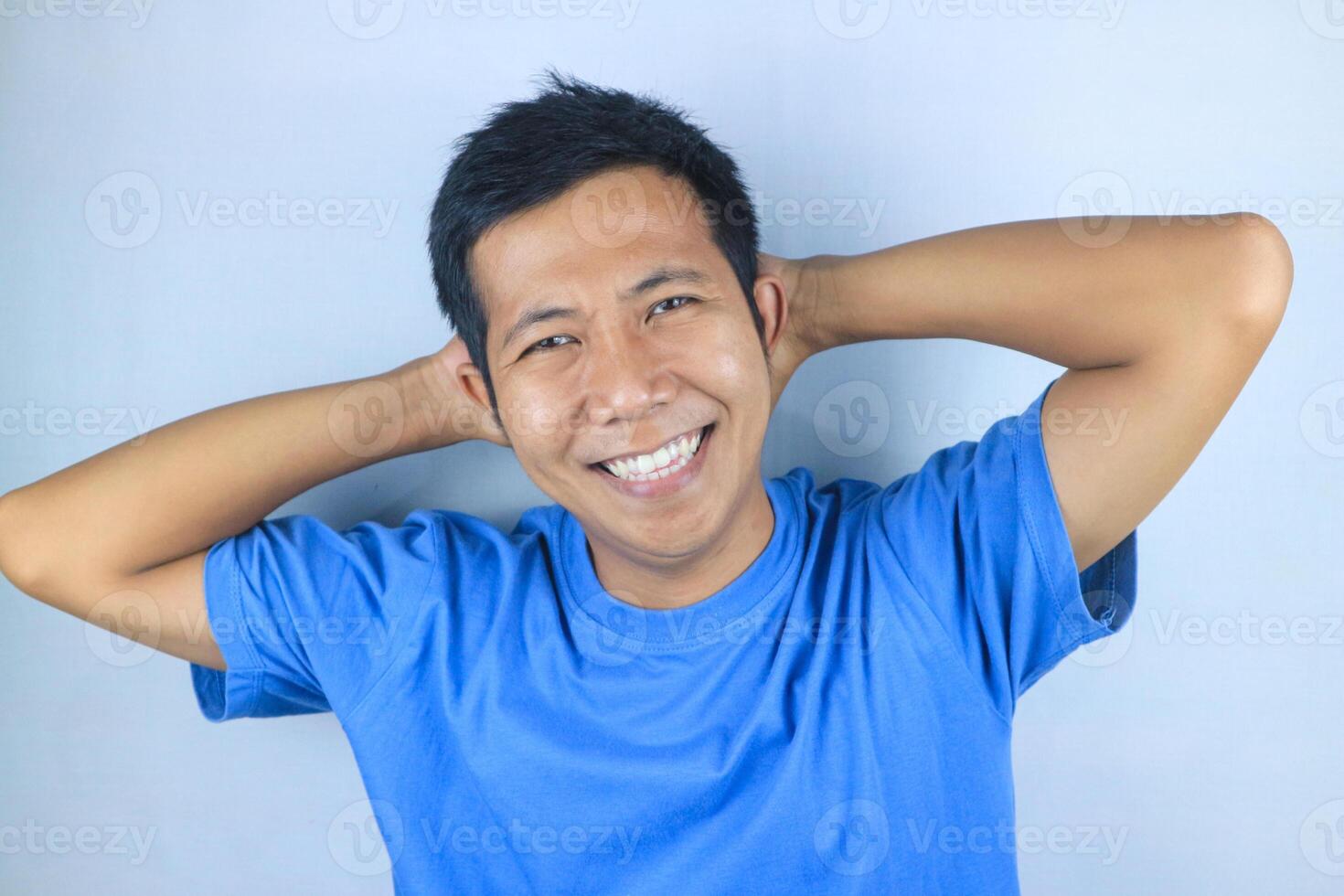 Smiling facial expression young asian man happy looking at camera, isolated on white background photo