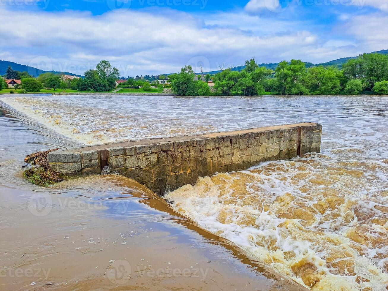 The river Berunka swollen after heavy rainfall and flood water crashing valley photo