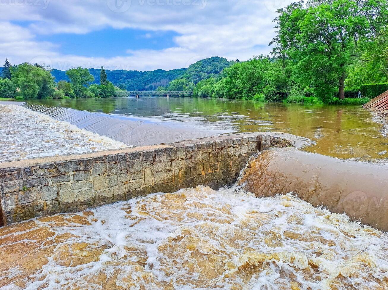 The river Berunka swollen after heavy rainfall and flood water crashing valley photo