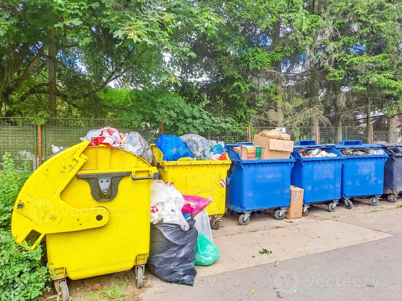 Dumpsters being full with garbage. Trash can overflowing litter pollution photo